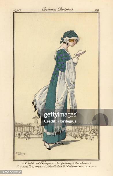 Woman reading a letter wearing a dress and toque hat of sea-green silk velvet edged with ermine. Ermine shawl and muff. Robe et toque de velours de...