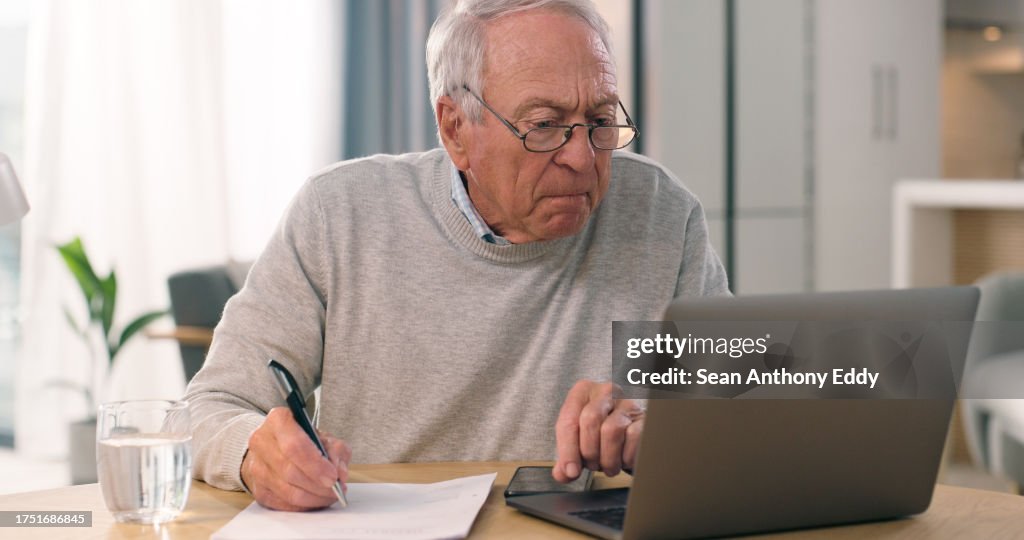 Laptop, paper and senior man reading, analysis and writing home summary of retirement pension, insurance or finance. Paperwork, computer or old person check financial info, web report or bank account