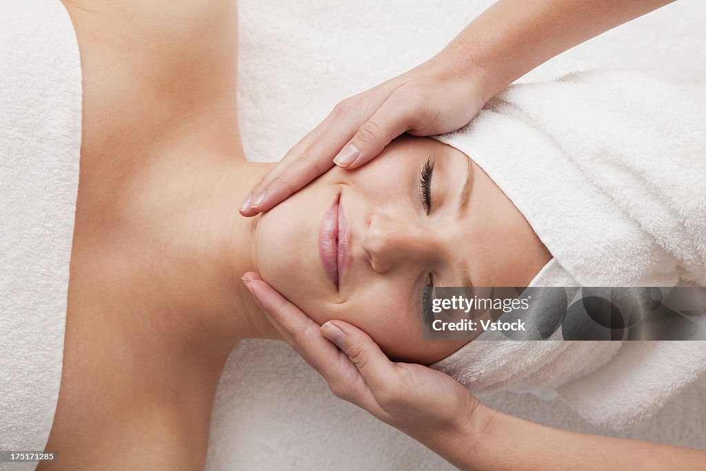 Woman receiving face massage