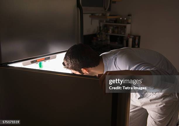 usa, new jersey, jersey city, man opening fridge at night - 12 o'clock stock pictures, royalty-free photos & images