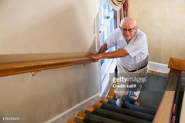 senior man climbing stairs - staircase stock pictures, royalty-free photos & images