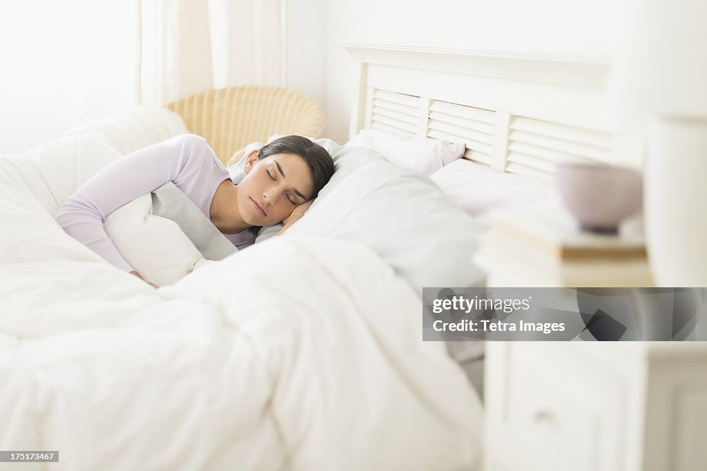 USA, New Jersey, Jersey City, Woman sleeping in bed