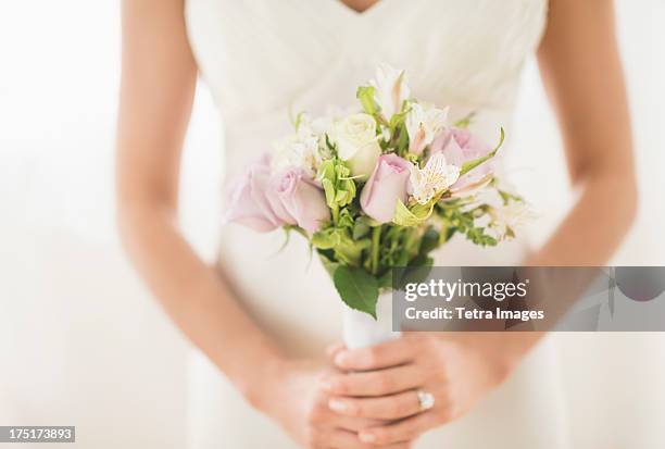 bride holding bouquet - bride bouquet stock pictures, royalty-free photos & images