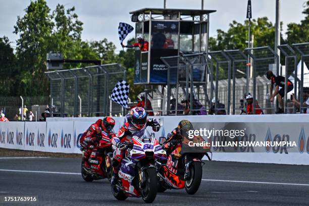 Prima Pramac's Spanish rider Jorge Martin celebrates as he crosses the finish line ahead of Red Bull KTM Factory Racing's South African rider Brad...