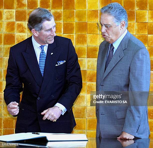 Fernando Henrique Cardoso , president of Brazil, talks with Prince Charles of Wales 04 March 2002 whiel he signes a book of honor upon his arrival in...