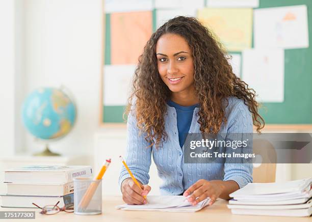 usa, new jersey, jersey city, portrait of elementary school teacher in class - tetra images teacher stock pictures, royalty-free photos & images