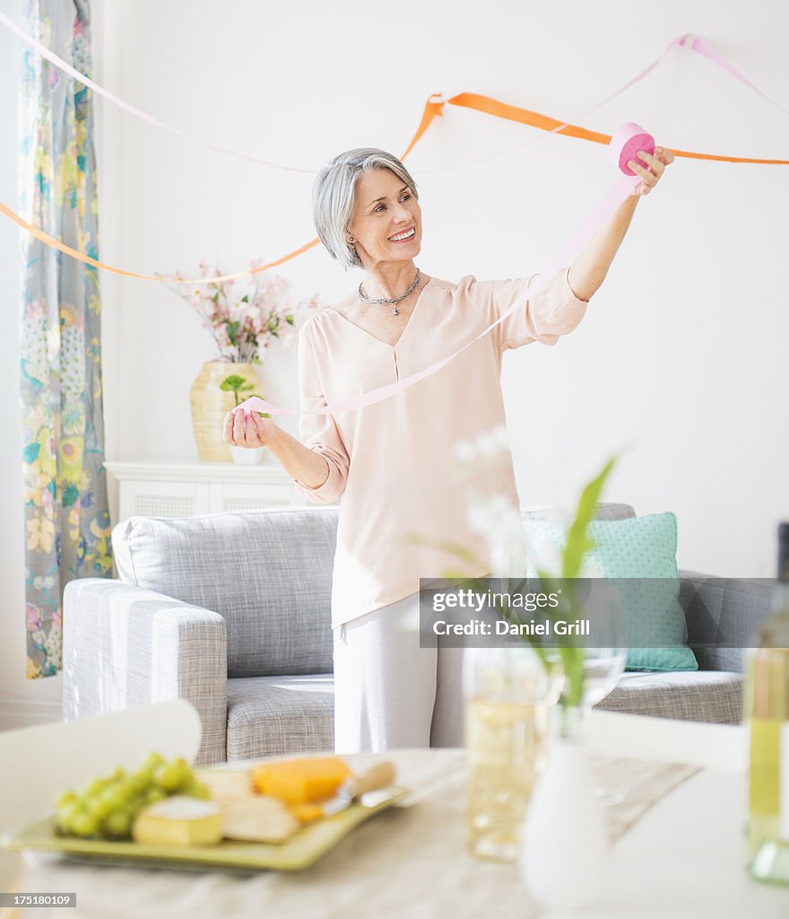 USA, New Jersey, Jersey City, Portrait of woman decorating living room