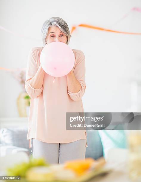 usa, new jersey, jersey city, portrait of woman blowing balloon - fest 2013 day 1 stock-fotos und bilder