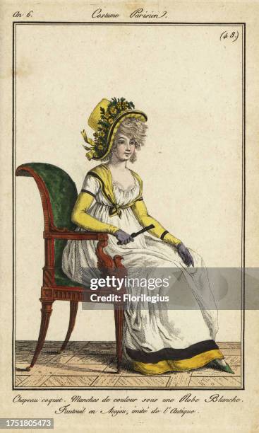 Fashionable woman in an imitation antique chair, 1798. She wears a coquet hat decorated with flowers and ribbons. Yellow sleeves and yellow kechief...
