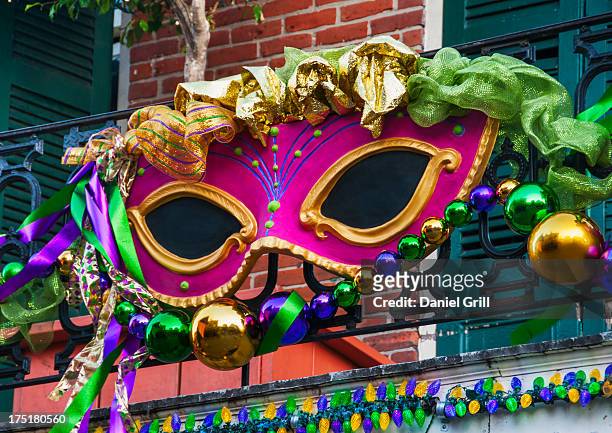 usa, new orleans, louisiana, mardi gras mask hanging on balcony's railing - new orleans foto e immagini stock
