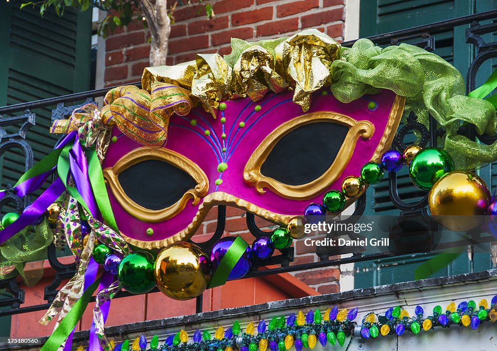 USA, New Orleans, Louisiana, Mardi Gras mask hanging on balcony's railing