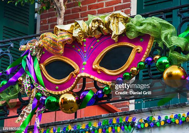 usa, new orleans, louisiana, mardi gras mask hanging on balcony's railing - mardi gras new orleans bildbanksfoton och bilder