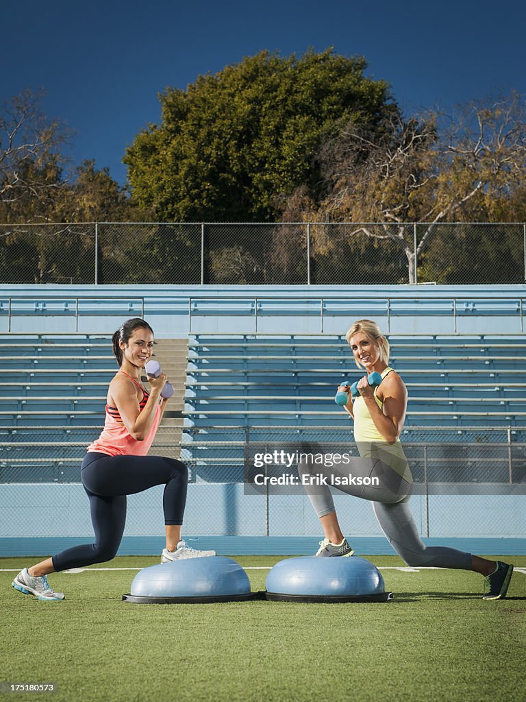 USA, California, Los Angeles, Two women exercising at sports field