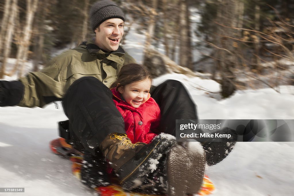 USA, Utah, Highland, Young man sledding with girl (2-3)