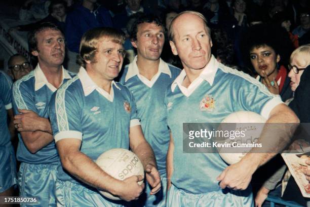 Footballers Francis Lee and Bobby Charlton , both wearing Manchester City kit, with Pat Crerand and Mike Summerbee of Manchester City behind them, in...