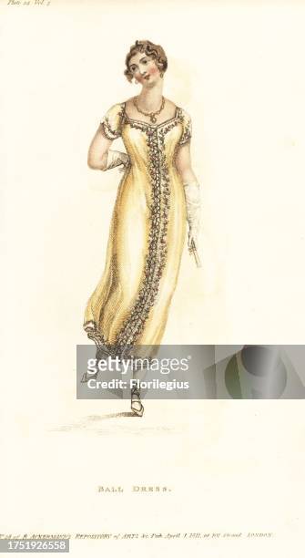 Regency woman dancing a cotillon in a ball gown, 1811. Amber crepe gown embroidered with lilies and Persian roses in chenille, worn over a white...