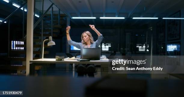 excited woman, dancing and celebration at night for success, achievement or competition at office. happy female person working late with smile for winning, victory or bonus promotion at workplace - sales competition stock pictures, royalty-free photos & images