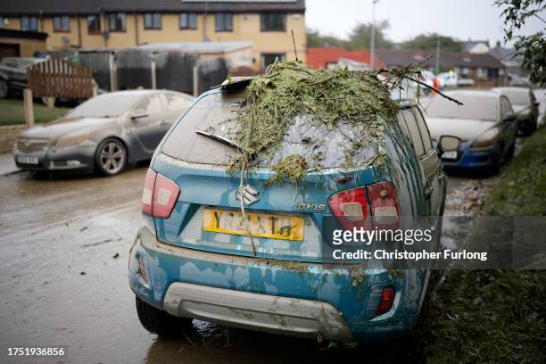 Damage is seen on a residents car as flood waters recede in the village of Catcliffe after Storm Babet flooded home, business and roads on October...