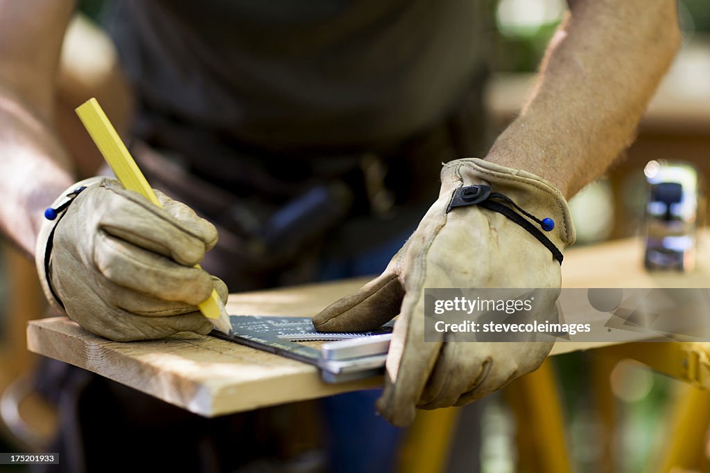 Carpenter Measuring A Wooden Plank.