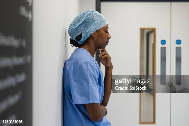 doctor feeling concerned - worried doctor stock pictures, royalty-free photos & images