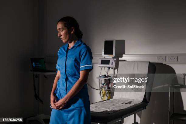 deeply concerned doctor - three quarter length stock pictures, royalty-free photos & images