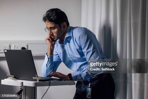 doctor working late - stubble stock pictures, royalty-free photos & images