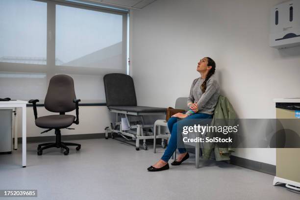 waiting in doctors examination room - anxiously waiting stock pictures, royalty-free photos & images