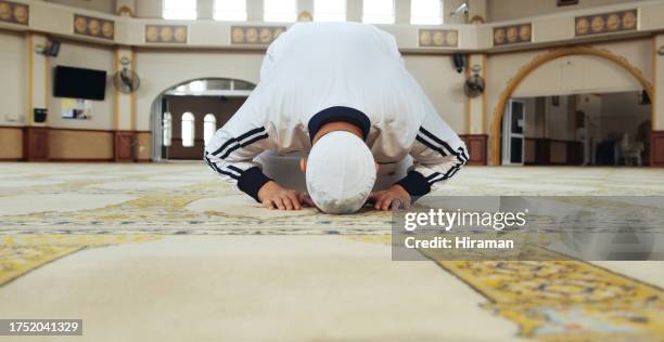 muslim man, kneeling and praying in mosque for faith, respect or islamic commitment to allah. moslem culture, salah and prayer in sujood for spiritual worship, holy religion or trust in god for peace - namaz stock pictures, royalty-free photos & images