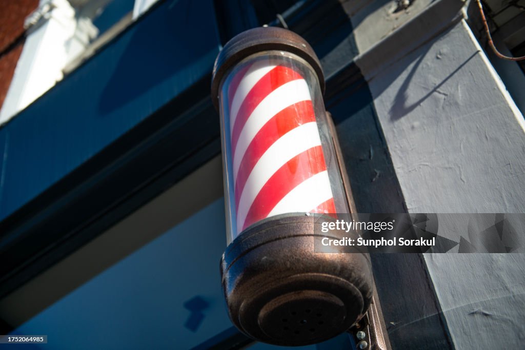 Barber's pole with red and white stripes, London Uk