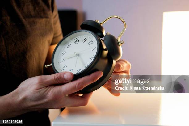 setting up alarm clock - daylight saving time foto e immagini stock