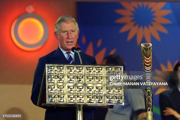 Britain's Prince Charles, Prince of Wales gives a speech after placing the Queen's Baton in its holder during the XIX Commonwealth Games opening...