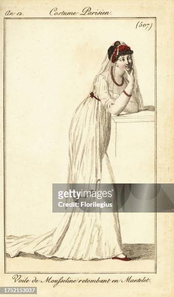 Fashionable woman in a muslin veil falling over her hair and shoulders like a capelet. She wears a diadem of red roses, red necklace, bracelet and...