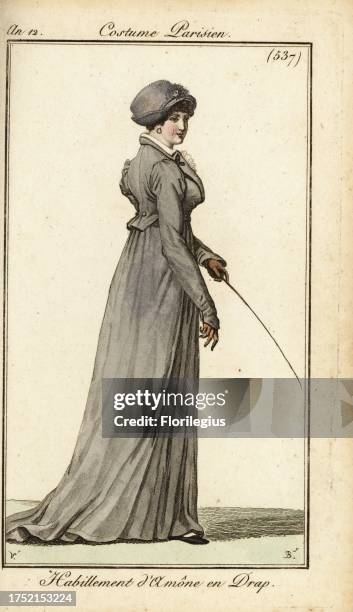 Woman in riding outfit, Paris, 1804. She wears a bonnet, wool ridingcoat, leather gloves and holds a riding crop. Habillement d'amazone en drap....