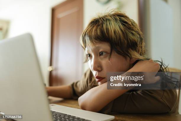 young gen-z female looking at screen - college student thinking stock pictures, royalty-free photos & images
