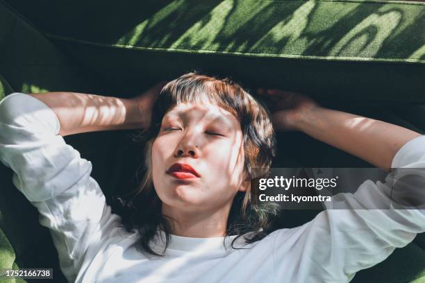 young gen-z female relaxing at home - gen i stock pictures, royalty-free photos & images