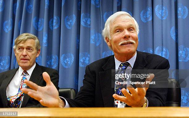 Time Warner Vice Chairman Ted Turner speaks at United Nations headquarters as Timothy Wirth, president of the UN Foundation listens December 11, 2002...