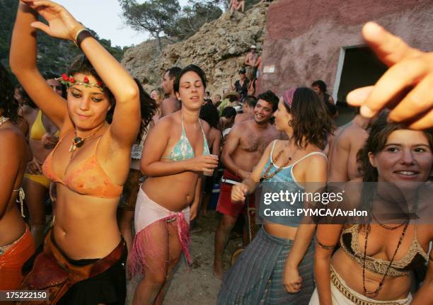 Hippy girls dancing, Sunset beach party, Benirras Beach, Ibiza, July 2006.