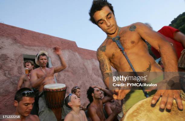 Tattooed hippy drummer, Sunset beach party, Benirras Beach, Ibiza, July 2006.
