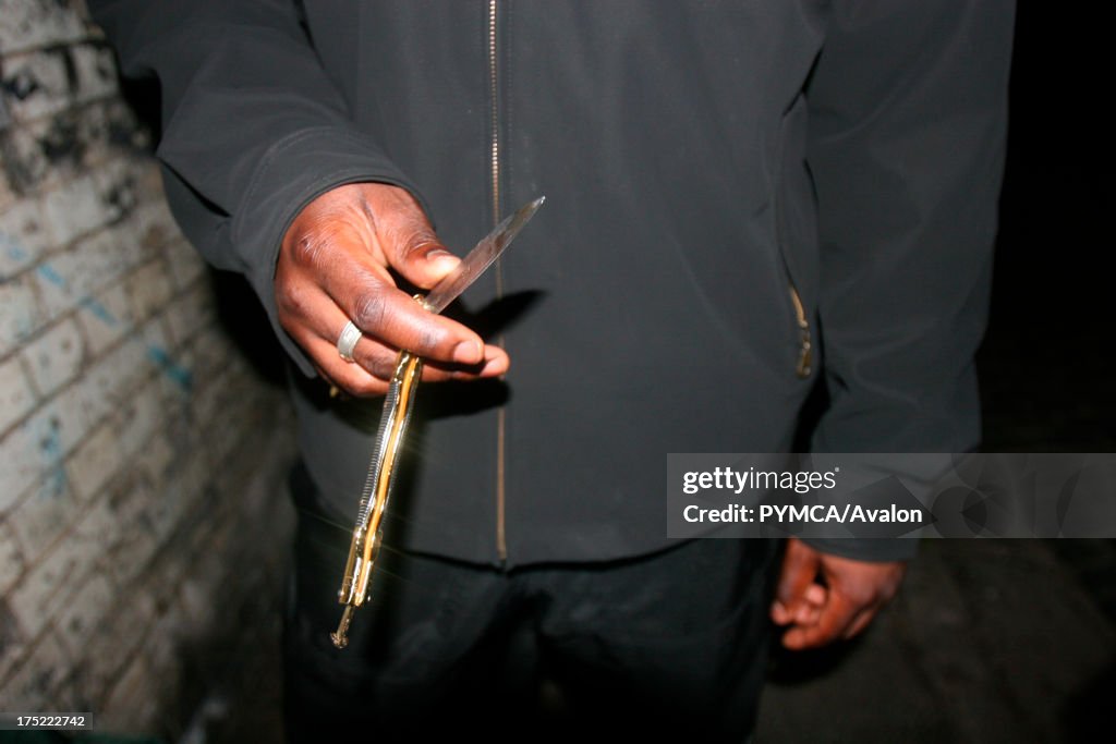Close-up of a youth holding a 'butterfly' knife, London, UK 2006