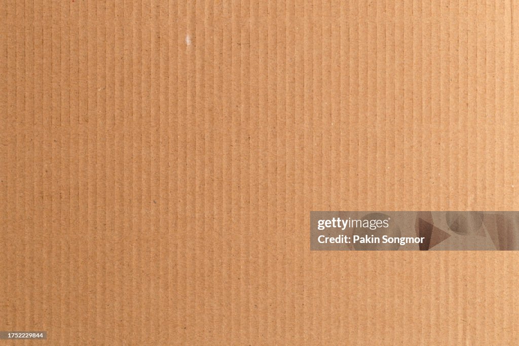 Brown color eco recycled kraft paper sheet texture cardboard background.
