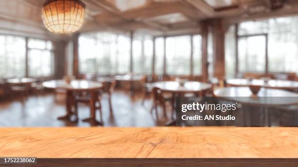 wooden board empty table in front of blurred background.  brown wood over blur in coffee shop. can be used for display or montage your products. mock up for display of product. - arbeitsplatte stock-fotos und bilder