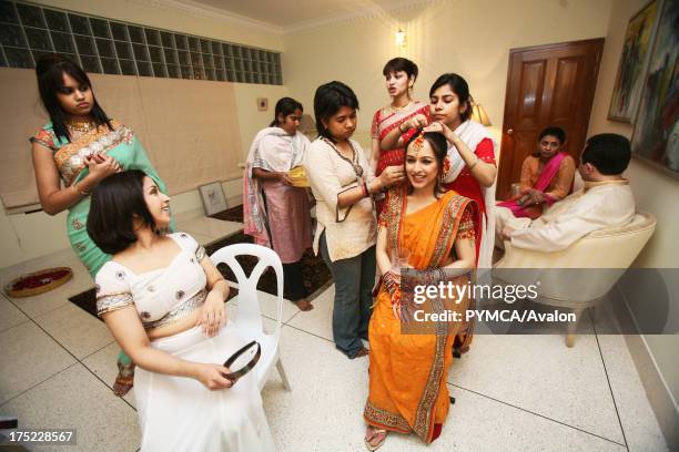 Wedding preparations. Family and friends come together to help prepare the Bride, Bangladesh, 2007.