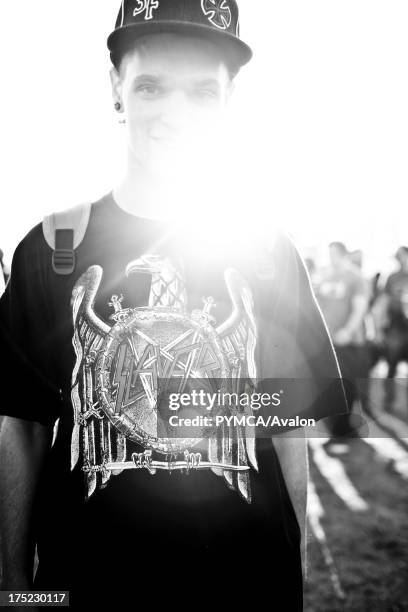 Boy smiling at camera in baseball cap, Reading Festival UK.