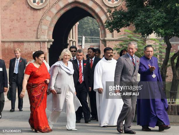Britain's Prince Charles and his wife Camilla, Duchess of Cornwall, walk with Bishop of Lahore Alexandar Johan Malik and his wife Shamim Malik during...