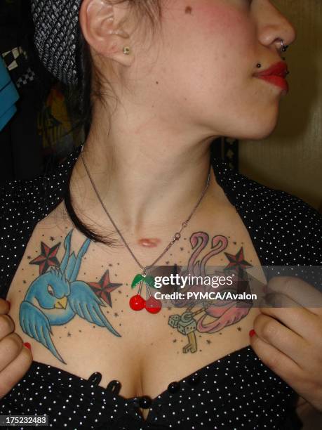 Rockabilly girl shows off her chest tattoos, Santiago, Chile, 2007.