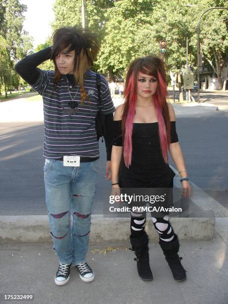 An Emo boy and girl with pink dyed hair looking serious on the street, Santiago, Chile 2007.