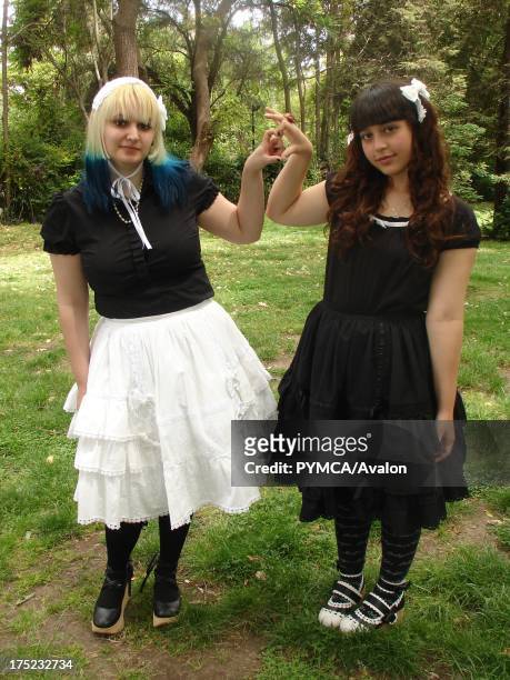 Two Gothic Lolita friends making a heart sign with their hands, Santiago, Chile 2007.