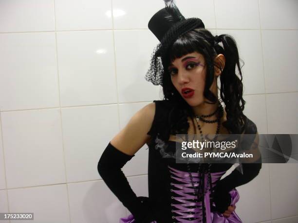 Goth girl wearing a corset and minature top hat striking a pose for the camera, Santiago, Chile 2008.