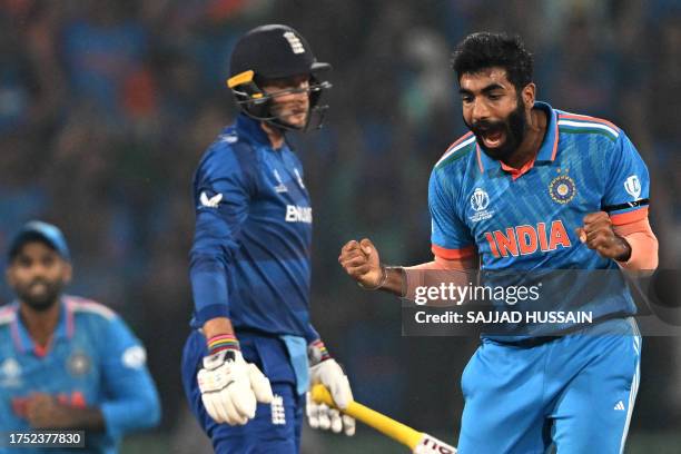 India's Jasprit Bumrah celebrates after taking the wicket of England's Joe Root during the 2023 ICC Men's Cricket World Cup one-day international...