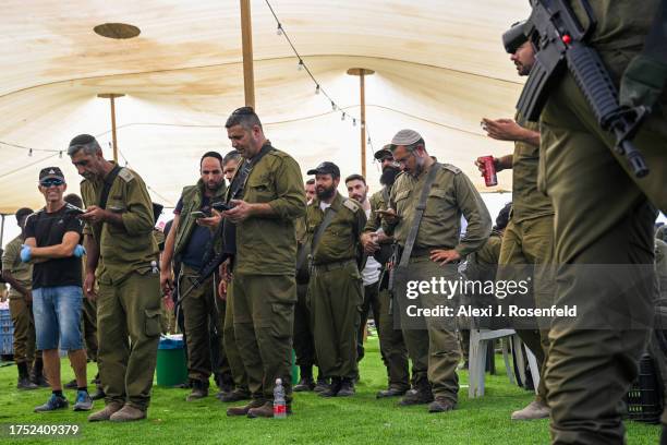 Observant soldiers participate in the 'Mincha' prayer service at a rest stop on October 23, 2023 in Southern Israel. Volunteers from across the...